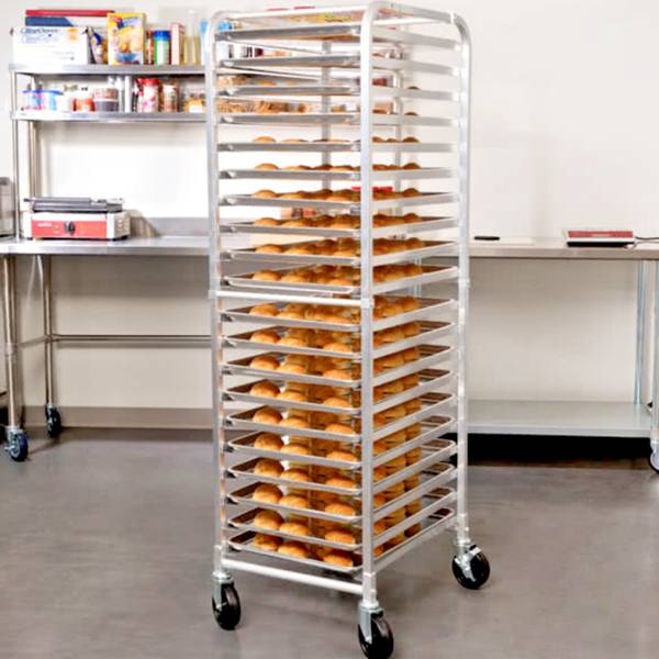 Several layers of breads on the commercial cooling racks and cooling racks on the sheet pans.