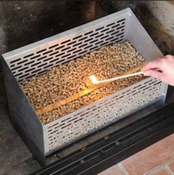 A person is going to ignite the pellet in the perforated pellet baskets.
