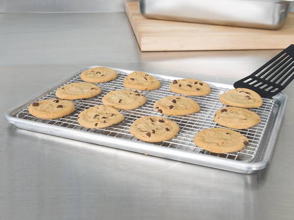 A piece of stainless steel cooling rack is placed on the sheet pan.