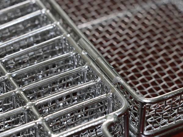 A stainless steel double layer ultrasonic cleaning baskets on the table.