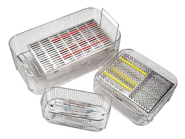 Three stainless steel cleaning baskets and several surgical instruments in the baskets.